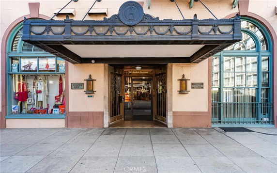 Front entrance of a building with decorative awning and shop window.