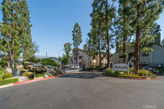 Front view of residential buildings with gated entry and landscaping.