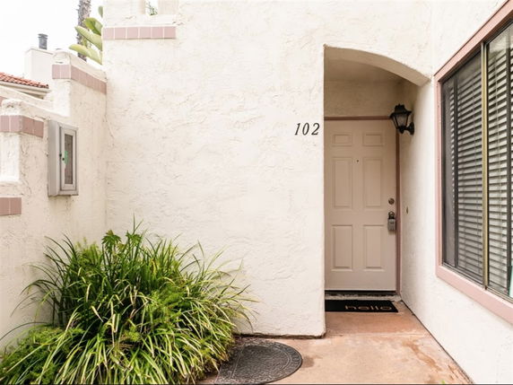 Front view of a building entrance with a single door and window.