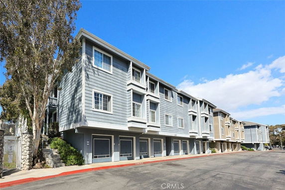 Front view of a multi-story residential building with a modern design.