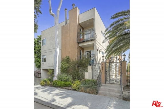 Front view of a multi-story house with a small balcony.
