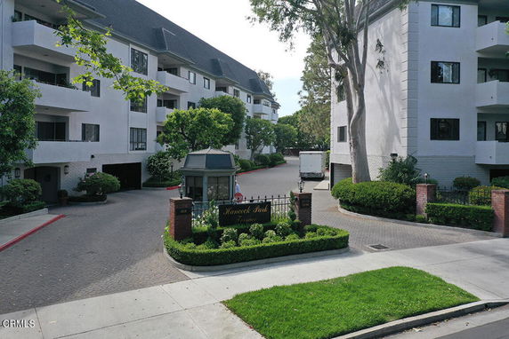 Front view of a residential building complex with multiple stories and balconies.