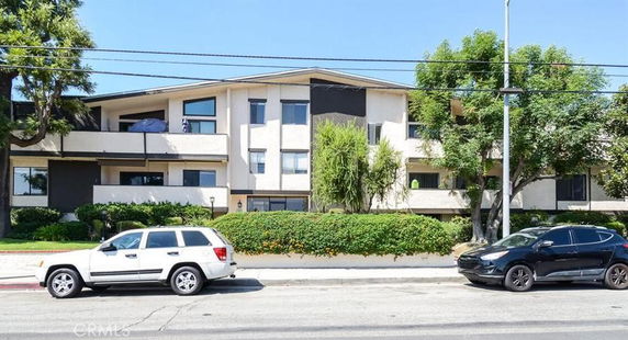 Front view of a multi-story residential building with balconies