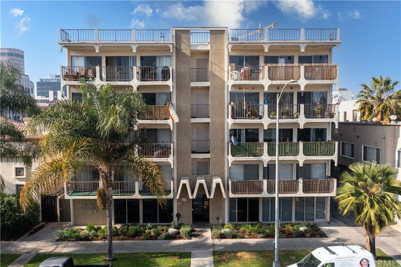 Front view of a multi-story residential building with balconies.