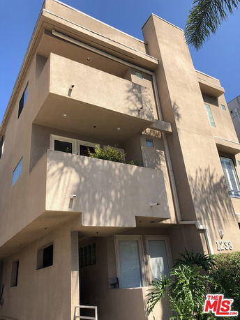 Front view of a multi-story building with balconies.
