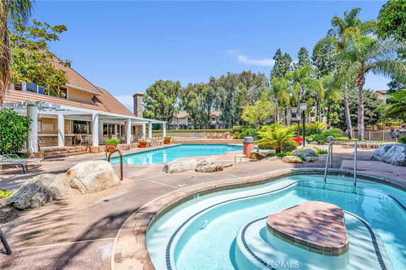 Outdoor swimming pool area with a clubhouse.