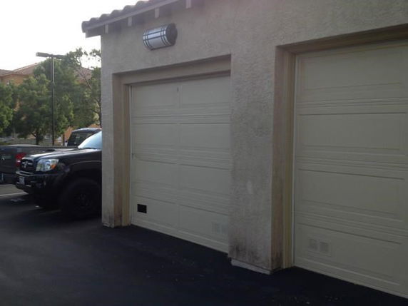 Two-car garage with closed doors attached to a building.