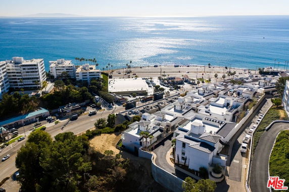 Wide angle view of coastal buildings and ocean.