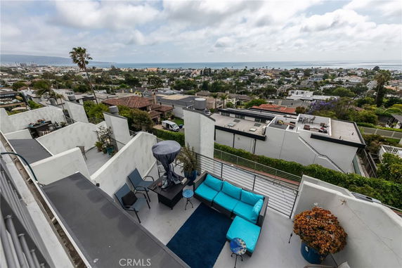 Rooftop with outdoor seating and ocean view.