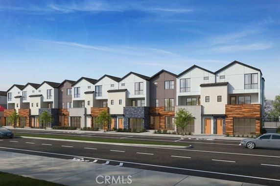 Front view of a modern multi-story townhouse complex.