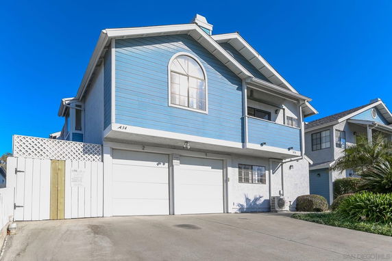 Front view of a two-story house with a blue facade and double garage.