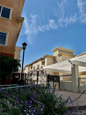 Front view of a multi-story building with a gated entrance.