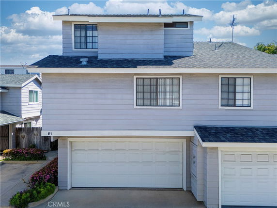 Front view of a multi-story house with a double garage.