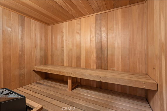 Wooden interior of a sauna room with a bench.
