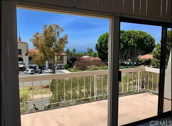 View from a balcony looking out towards buildings and trees