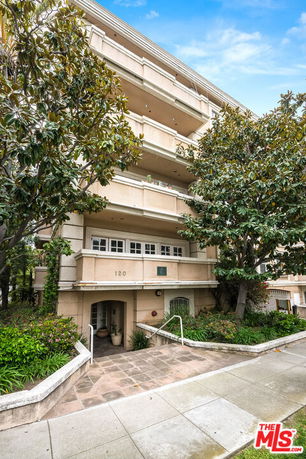 Front view of a multi-story residential building with balconies.