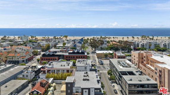 Panoramic view of urban area with buildings and ocean in the background.