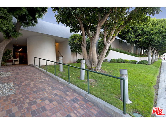 Front view of a building with a modern design and landscaped area.