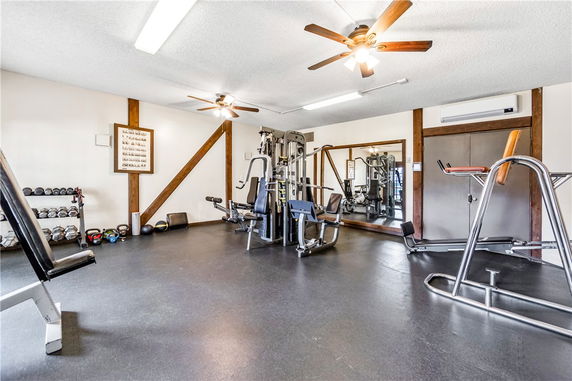 Indoor gym area with workout equipment and mirrors on the wall.