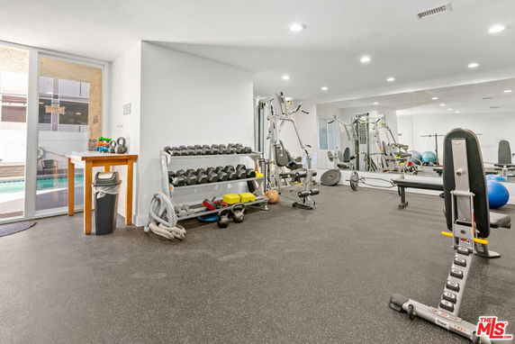 Indoor gym area with exercise equipment and weights