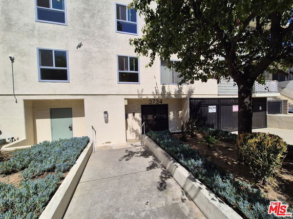 Front view of a multi-story building with a garage entrance.