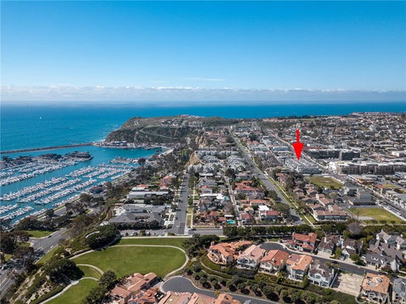 Panoramic view of a coastal residential area with houses and a marina.