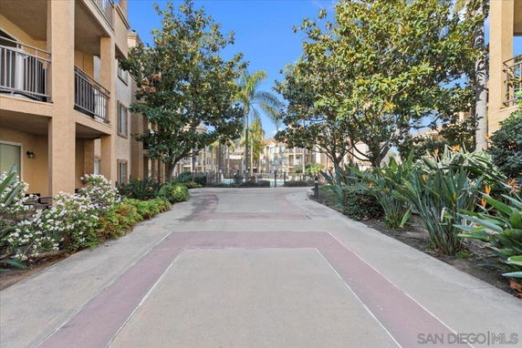 Outdoor view of apartment complex walkway with landscaping.