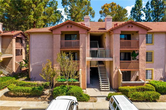 Front view of a multi-story residential building with balconies.