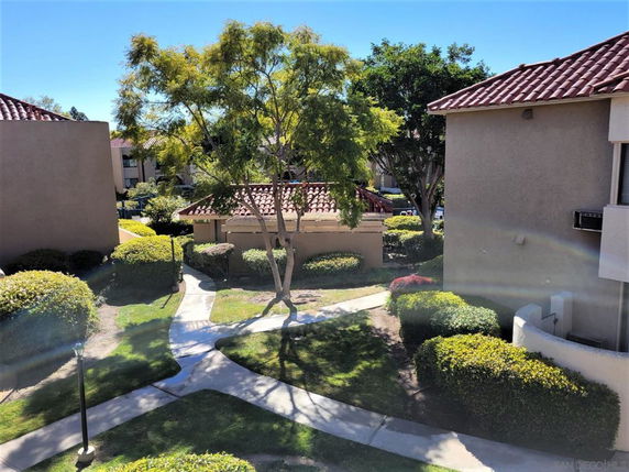 View of pathways and greenery between residential buildings.