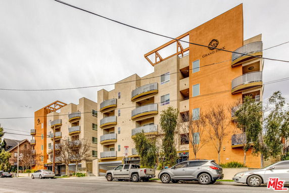 Front view of a multi-story apartment building with balconies.