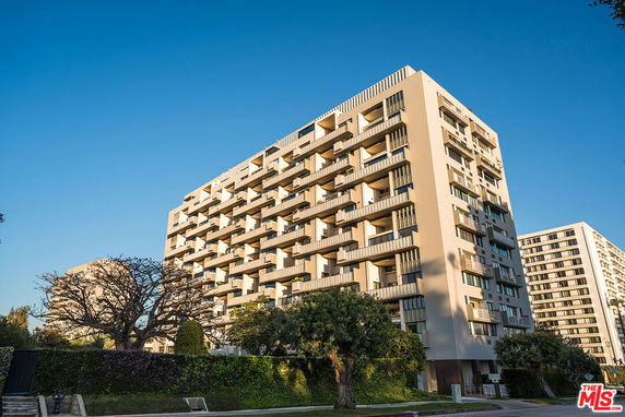 Front view of a multi-story residential building with balconies.