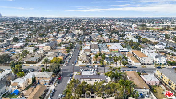 Wide aerial view of a residential neighborhood with numerous houses and streets.