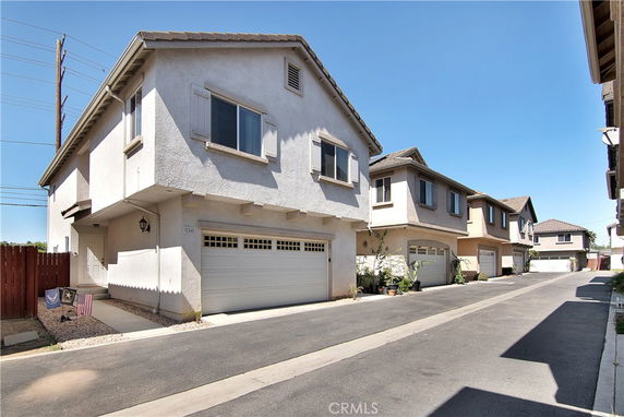Front view of a two-story house with a double garage and stucco exterior.