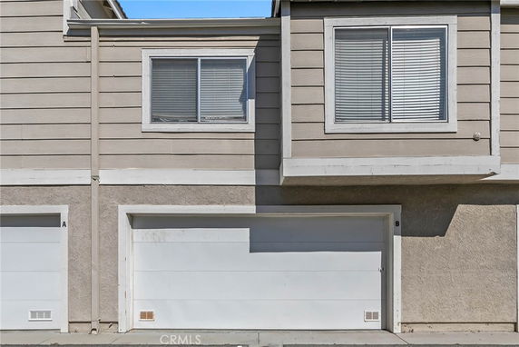 Front view of a building with a garage and windows above.