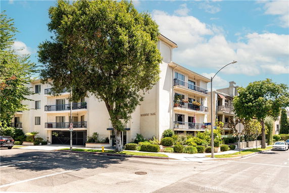 Front view of a multi-story apartment building with balconies.