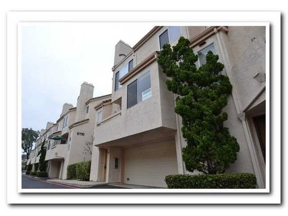 Front view of a multi-story building with a garage.