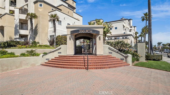 Front view of a multi-story building with an entrance and staircase.