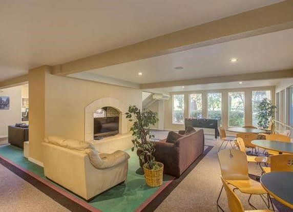 Interior of a recreational area with seating and tables.