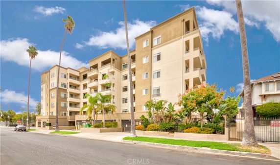 Front view of a multi-story apartment building with balconies.