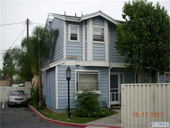 Front view of a two-story house with blue siding and white trim.