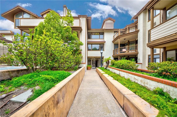 Front view of a multi-story residential building with balconies.