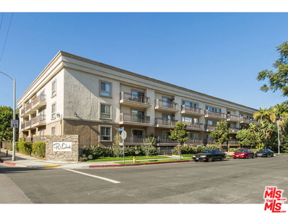 Front view of a multi-story apartment building with balconies.