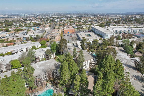 Aerial view of a residential area with multiple apartment buildings surrounded by trees.