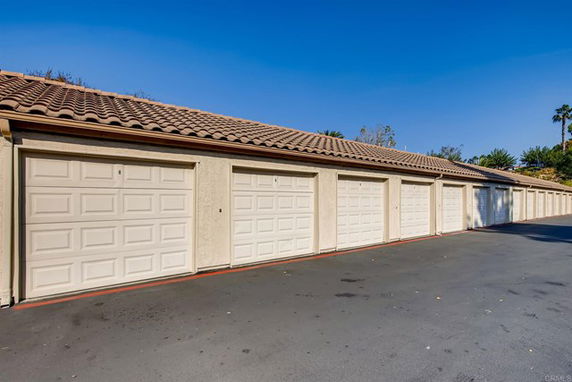 Outdoor parking area with multiple garage doors.