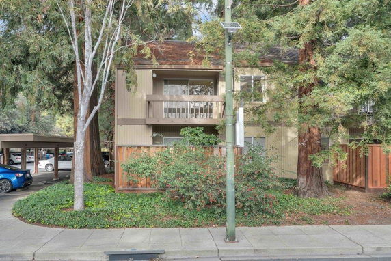 Front view of a two-story residential building with a balcony.
