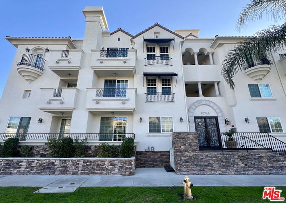 Front view of a multi-story residential building with balconies.