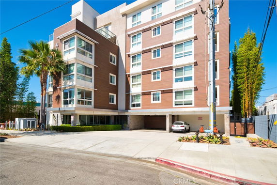 Front view of a multi-story apartment building with a modern design.