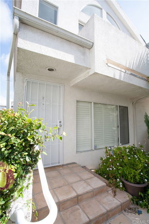 Front view of a house with a gated door and windows.