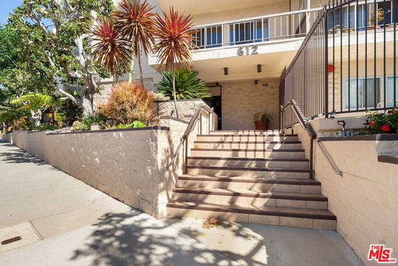 Front view of a building with a staircase entrance.