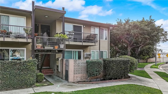 Front view of a two-story apartment building with balconies.